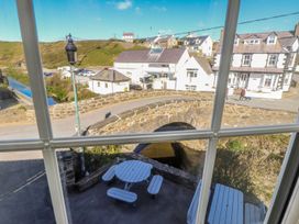 A view from a window showing a bridge and buildings at Hen Blas Pwllheli