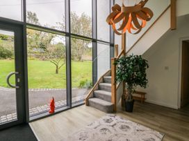 An entrance hall with a staircase and light fixture at 10 Rayrigg Rise in Bowness-On-Windermere