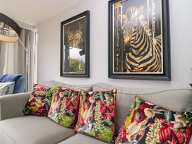 A living room with a sofa and artwork at 10 Rayrigg Rise Bowness-On-Windermere