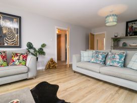 A living room with a sofa and artwork at 10 Rayrigg Rise Bowness-On-Windermere