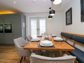 A dining room with a wooden table and chairs at 10 Rayrigg Rise Bowness-On-Windermere