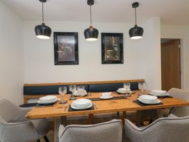 A dining room with a wooden table and chairs at 10 Rayrigg Rise Bowness-On-Windermere