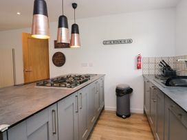 A kitchen with a cooker and cabinets at 10 Rayrigg Rise Bowness-On-Windermere