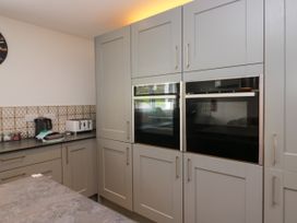 A kitchen with built-in ovens and appliances at 10 Rayrigg Rise Bowness-On-Windermere
