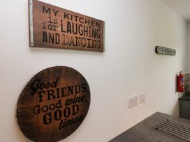 A kitchen with decorative signs on the wall at 10 Rayrigg Rise Bowness-On-Windermere