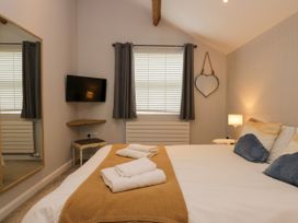 A bedroom with a bed and television at 10 Rayrigg Rise in Bowness-On-Windermere