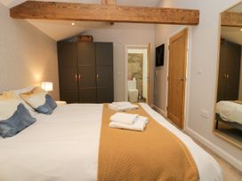 A bedroom featuring a bed with pillows and a wardrobe at 10 Rayrigg Rise Bowness-On-Windermere