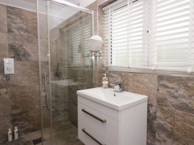A bathroom with a shower and sink at 10 Rayrigg Rise Bowness-On-Windermere