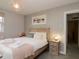 A bedroom with a bed and bedside tables at 10 Rayrigg Rise Bowness-On-Windermere