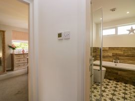 A bathroom featuring a bath, toilet, and sink at 10 Rayrigg Rise in Bowness-On-Windermere