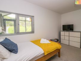 A bedroom with a bed and television at 10 Rayrigg Rise Bowness-On-Windermere