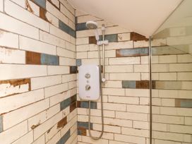 A shower with tiles and control panel at 10 Rayrigg Rise Bowness-On-Windermere