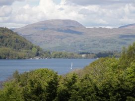 A scenic view of a lake and mountains at 10 Rayrigg Rise Bowness-On-Windermere