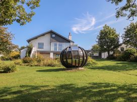 A house with a garden and a glass structure at 10 Rayrigg Rise Bowness-On-Windermere