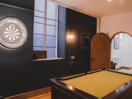 A game room with a dartboard and pool table at Chapel of Arts in Criccieth
