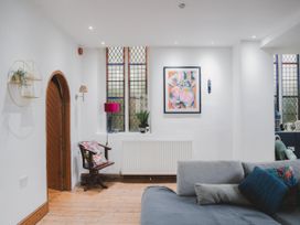 A living room with a window and artwork at Chapel of Arts in Criccieth