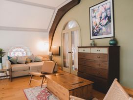 A living room with a sofa and coffee table at Chapel of Arts in Criccieth