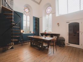A dining room with a table and chairs at Chapel of Arts in Criccieth