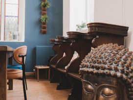 A dining room with a table and chairs at Chapel of Arts in Criccieth