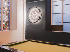 A game room with a pool table and a dartboard at Chapel of Arts in Criccieth
