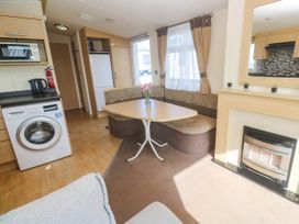 A living room with a table and sofa at No.73 Sennen Cove