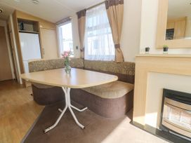 A dining area with a table and seating at No.73 Sennen Cove