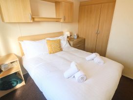 A bedroom with a bed and wardrobe at No.73 Sennen Cove
