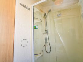 A shower with glass door in No.73 Sennen Cove