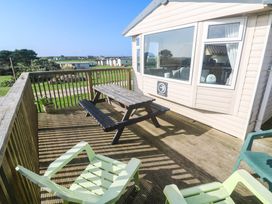 A deck with a picnic table and chairs at No.73 Sennen Cove