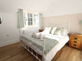 A bedroom with a bed and bedside tables at Osmington Cottage Annex 