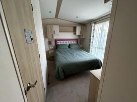 A bedroom with a bed and bedside tables at Coastfields Holiday Village in Skegness