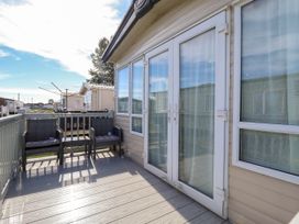 An outdoor area with chairs and a view at Coastfields Holiday Village in Ingoldmells