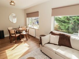 A living room with a dining table and sofa at Flat 2 in Tenby