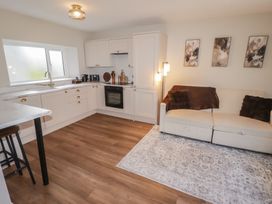 A kitchen with a couch and a dining area at Flat 3 in Tenby