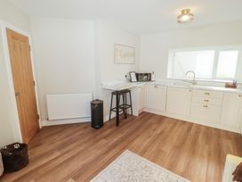 A kitchen with a sink and microwave at Flat 3 in Tenby