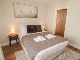 A bedroom with a bed and bedside table at Flat 3 in Tenby