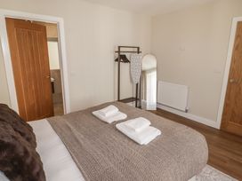 A bedroom with a bed and towels on it at Flat 3 in Tenby