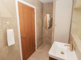 A bathroom with a sink and towel holder at Flat 3 in Tenby