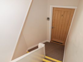 A stairway with a door labeled 3 at Flat 3 in Tenby