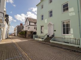 A street with buildings and a view of the sea at Flat 3 in Tenby