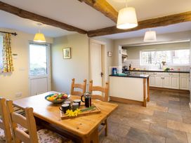 A kitchen with a dining area and counter at High Beck Kendal