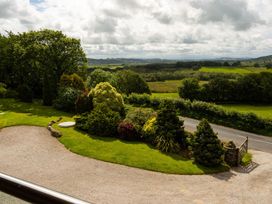 A garden with grass and trees at High Beck in Kendal