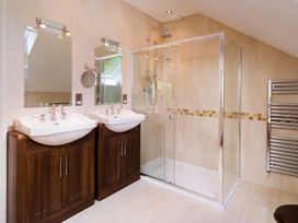 A bathroom with two sinks and a shower at High Beck Kendal