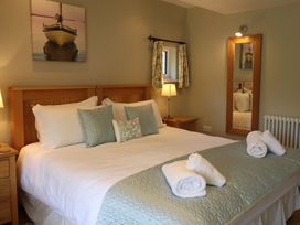 A bedroom with a bed and side tables at High Beck in Kendal