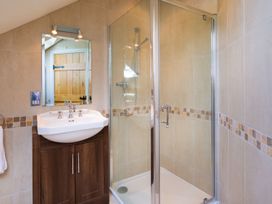 A bathroom with a sink and shower at High Beck in Kendal