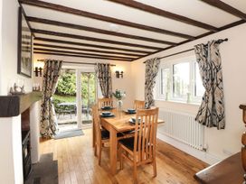 A dining room with a table and chairs at High Beck Cottage in Kendal