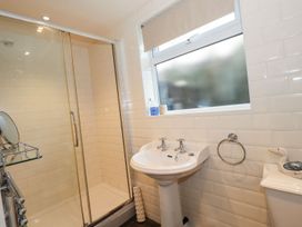 A bathroom with a shower and washbasin at High Beck Cottage Kendal