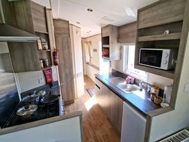 A kitchen with sink and stove at Haven Golden Sands Abi Marina in Mablethorpe