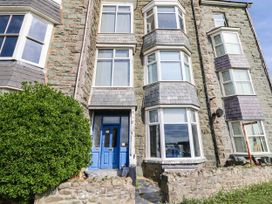 A building with a blue front door and large windows at Flat 1 Greenfields Barmouth