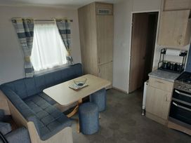 A dining area with a table and seating at St Osyth Beach in Clacton-on-Sea